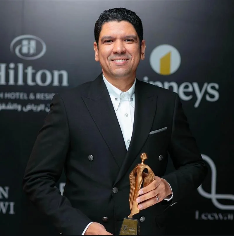 Eng. Ahmed Mohsen, Founder & CEO of NoVi Designs & Finishing, holding an award trophy