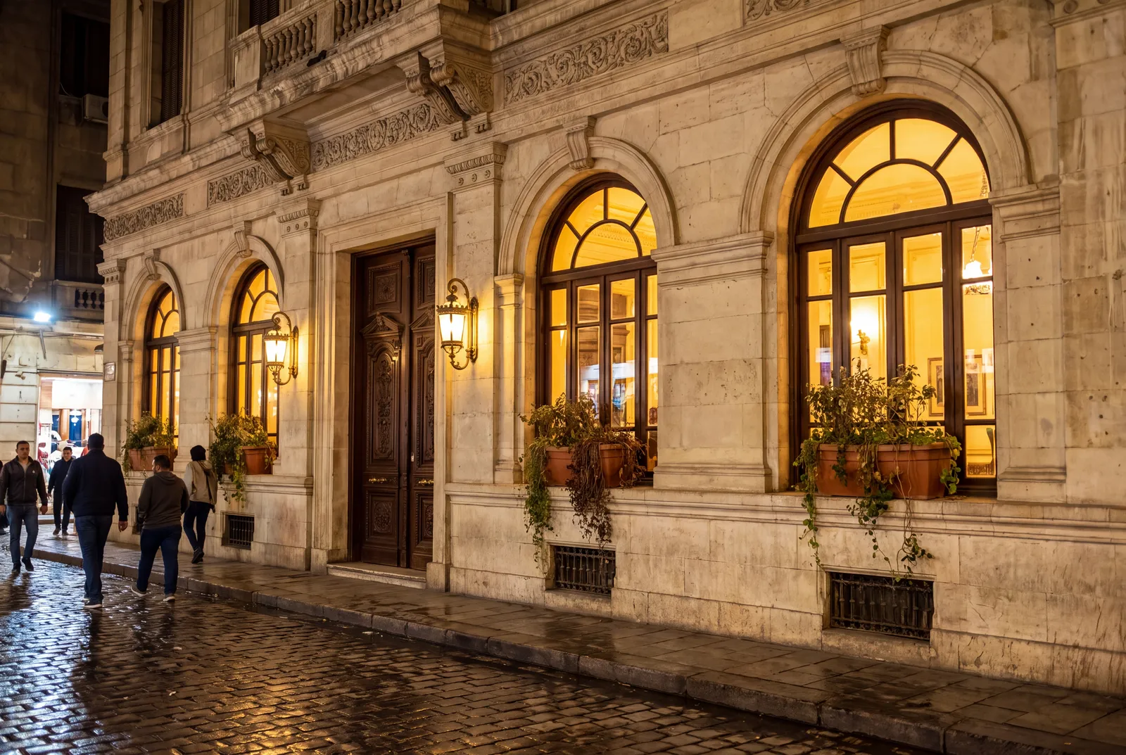 Heritage restaurant façade at night with arched windows