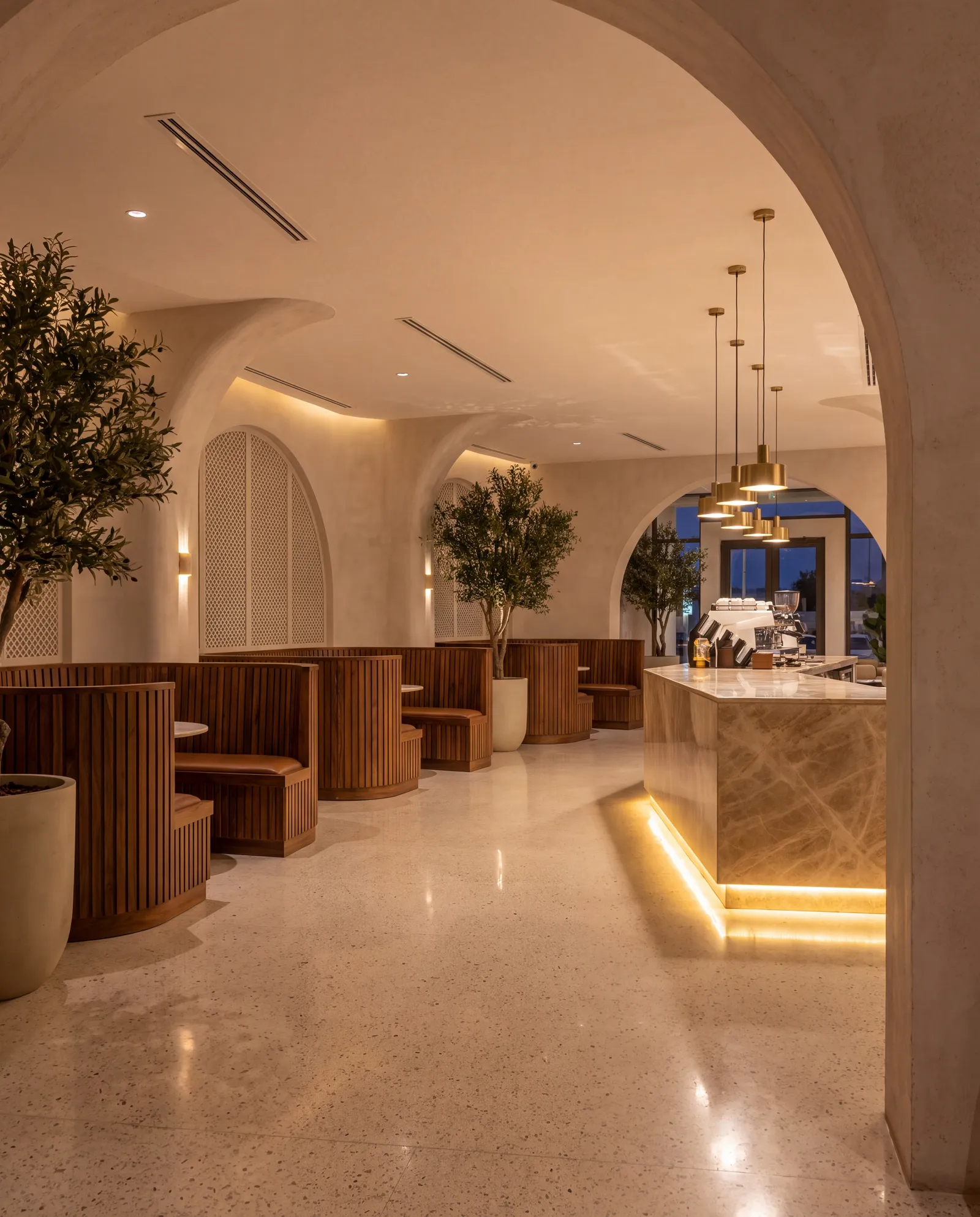 Finished café fit-out with walnut booths, terrazzo floor, olive trees and arches